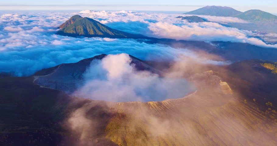 Aerial view Hyperlapse Drone shot of fog at Kawah Ijen volcano with turquoise sulfur water lake and sunrise light,Amazing nature landscape view at East Java,Indonesia, Timelapse fog in sunrise sky