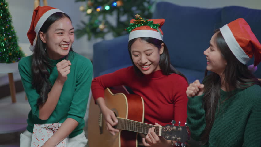 Family and friends decorate on the Christmas tree together with happy and joyful.