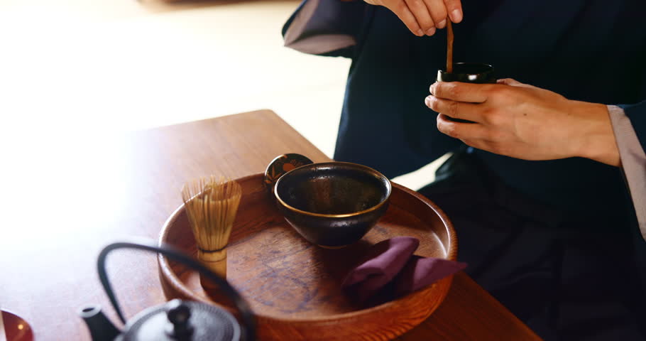 Tea ceremony, person and hands with powder for preparation, ritual and traditional healing in Japan. Japanese man, ceramics and matcha in home for detox beverage, antioxidants and zen in culture