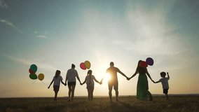 Happy family holding hands with balloons. Family celebrating birthday with balloons. Parents children holding hands. Colorful balloons add to family birthday joy. Bonding moments as family holds hands - Powered by Shutterstock - Get 15% off with code: PIKWIZARD15