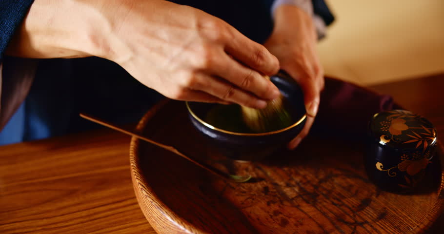 Man, hands and making green tea in home for ceremony, preparation and traditional healing in Japan. Japanese person, matcha and mixing with bamboo whisk for process, antioxidants and culture ritual