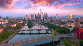 Frankfurt Aerial Flight through Frankfurt am Main, Germany. Skyline. New Skyscrapers. Urban Canyon in Sunset or Sunrise Light. Aerial Pedestal in Establishing Night Drone Shot. Glowing street lights - Powered by Shutterstock - Get 15% off with code: PIKWIZARD15