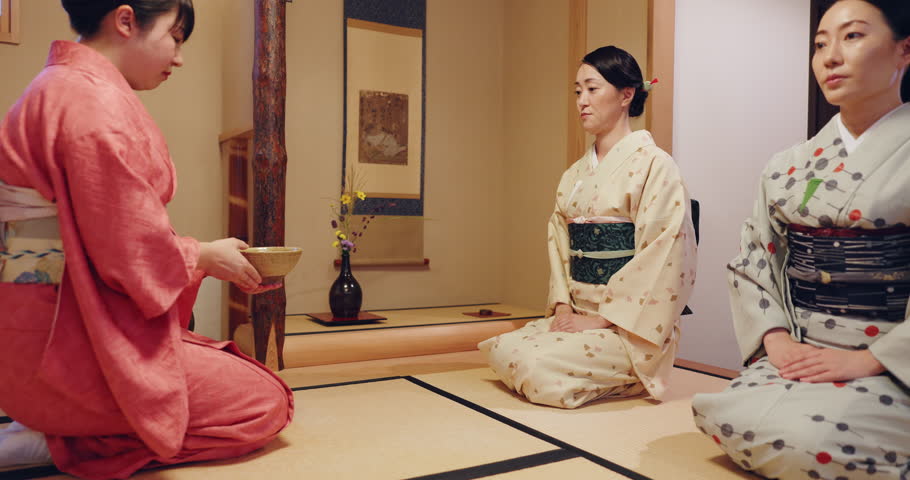 Japan, women and tea in ceremony with respect, Asian culture and honor tradition in home. Japanese people, kimono and bow in house for gratitude, harmony and mindfulness for inner peace in heritage