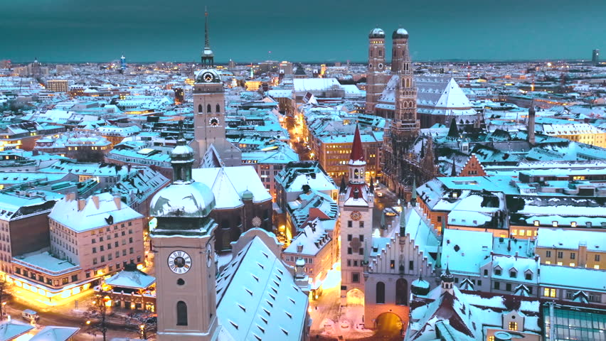 Beautiful aerial footage of Munich Frauenkirche gothic church, Marienplatz and the magestic New Town Hall, in the City of Munich Babaria Germany at winter snow, munich night christmas.