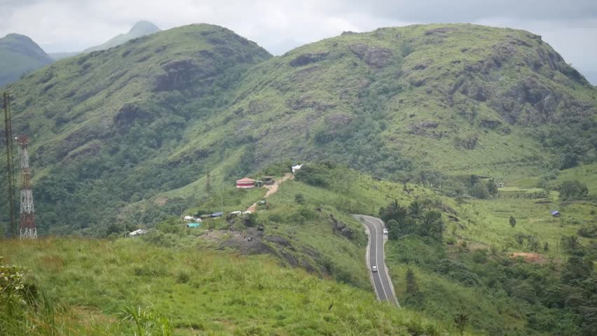 Vehicle Moving Near A Hill Top Road, Mountain Road With Vehicle Moving, Hill View, Valley In Kerala, Kerala Tourism, Backwaters, Elaveezhapoonchira, Kochi, Goa, Munnar, View Point, Destination, Hunt