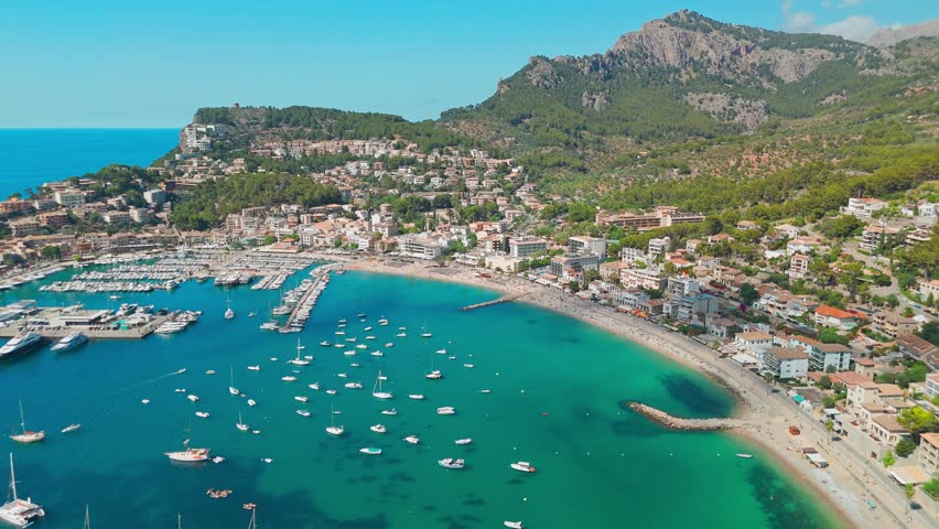 Aerial view of the summer resort town Port de Soller on Mallorca, Balearic Islands, Spain. The idyllic turquoise lagoon with moored yachts in it. Majorca, Spain.