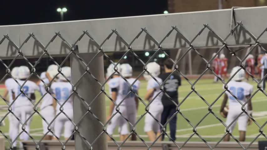 High school football team on field during night game 4k
