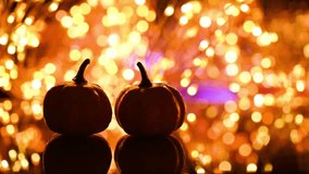 Happy Thanksgiving greeting card. Silhouette of pumpkins against a background of blurred flashing golden lights and bokeh. - Powered by Shutterstock - Get 15% off with code: PIKWIZARD15
