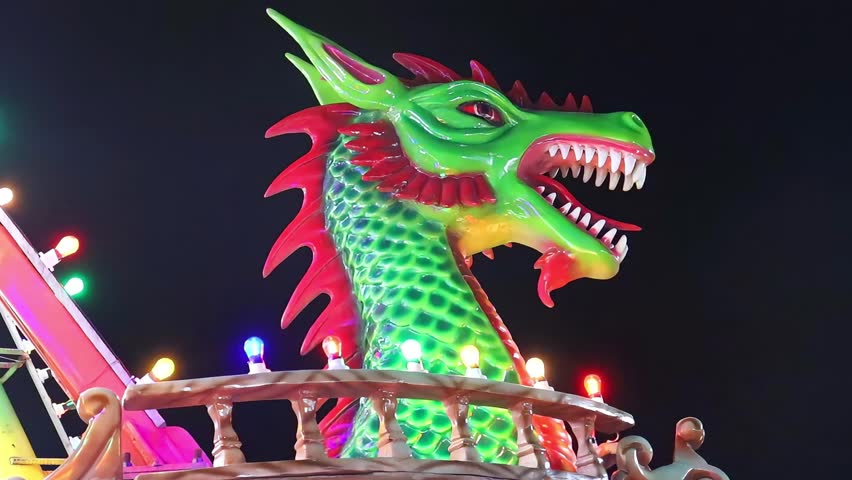 pirate ship Viking ride with dragon head at carnival amusement park. theme park attraction