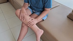 Leg pain calf area, muscle inflammation, cramp while woman sitting on sofa. Health care concept. - Powered by Shutterstock - Get 15% off with code: PIKWIZARD15