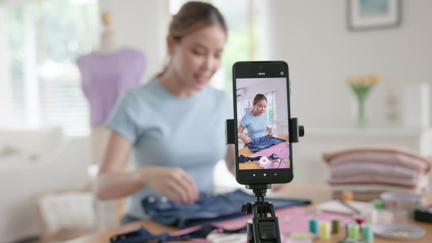 Asia people go green woman selfie live video vlog talk online teach make craft DIY eco second hand idea reuse old used fabric net zero waste fast fashion issue. Asian design hobby thrift retail store.