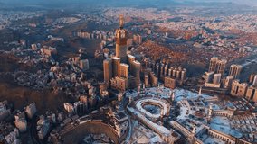 Aerial view of the Grand Mosque with the Kaaba, Islam’s holiest site, and the Abraj Al-Bait Clock Tower illuminated by early morning sunlight in the holy city of Mecca - Powered by Shutterstock - Get 15% off with code: PIKWIZARD15