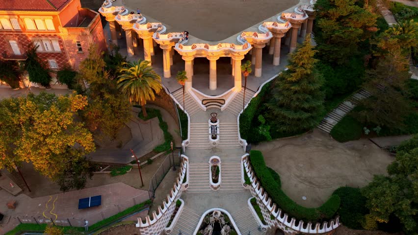 Aerial drone view of Park Guell at sunrise in Barcelona. Famous Antonio Gaudi architecture. Tourist spot in Barcelona, park Guell drone view