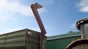 A tractor unloads a corn crop into a grain truck - Powered by Shutterstock - Get 15% off with code: PIKWIZARD15