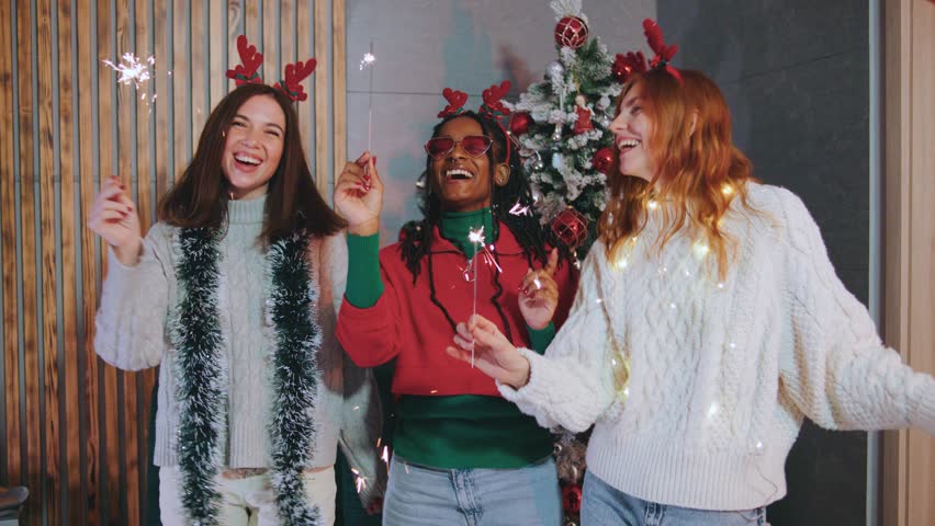 A group of joyful friends joyfully celebrating Christmas together, surrounded by vibrant sparkles and filled with cheerful expressions of joy, happiness, and excitement all around them