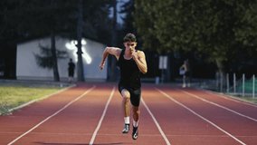 Vertical video of a young athlete running on an athletics track on a sunny morning along a lane of the track. Concept of sport and perseverance. - Powered by Shutterstock - Get 15% off with code: PIKWIZARD15