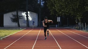 Vertical video of a young athlete running on an athletics track on a sunny morning along a lane of the track. Concept of sport and perseverance. - Powered by Shutterstock - Get 15% off with code: PIKWIZARD15