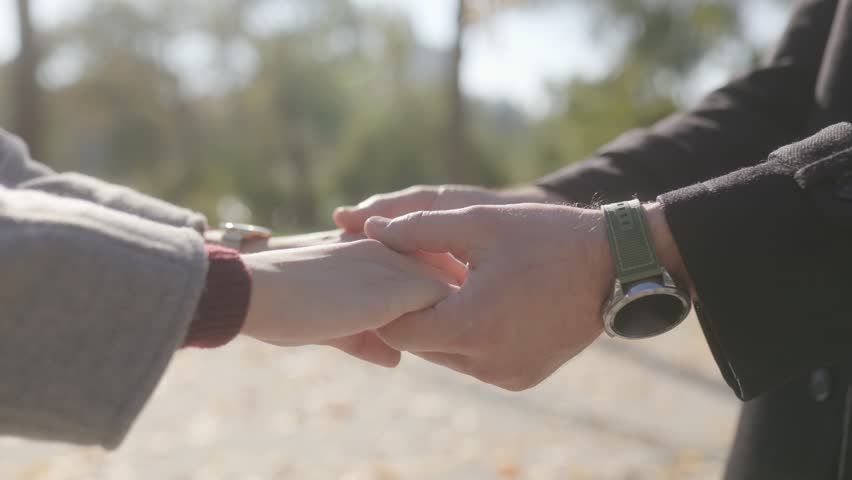 Close-up of a couple hands, holding together in a moment of intimacy and tenderness. This gesture captures the essence of trust and affection in a relationship.
