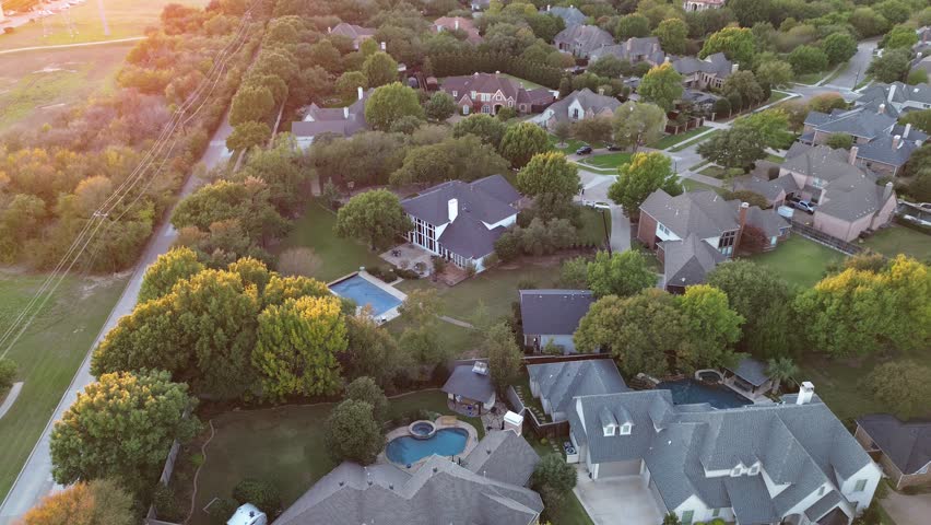 Mansion houses with large backyard swimming pool in upscale residential neighborhood near suburban park long walking biking path in Midway Road, Plano, Texas, lush greenery trees sunset, flyover. USA