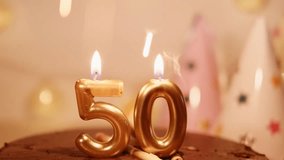 50 shape numbers golden candles and sparklers in a chocolate Birthday cake. A homely atmosphere of a happy Birthday party. Garlands and lights create comfort and warmth - Powered by Shutterstock - Get 15% off with code: PIKWIZARD15