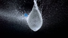 Popping water balloon on black background shooting with high speed camera, phantom flex. - Powered by Shutterstock - Get 15% off with code: PIKWIZARD15