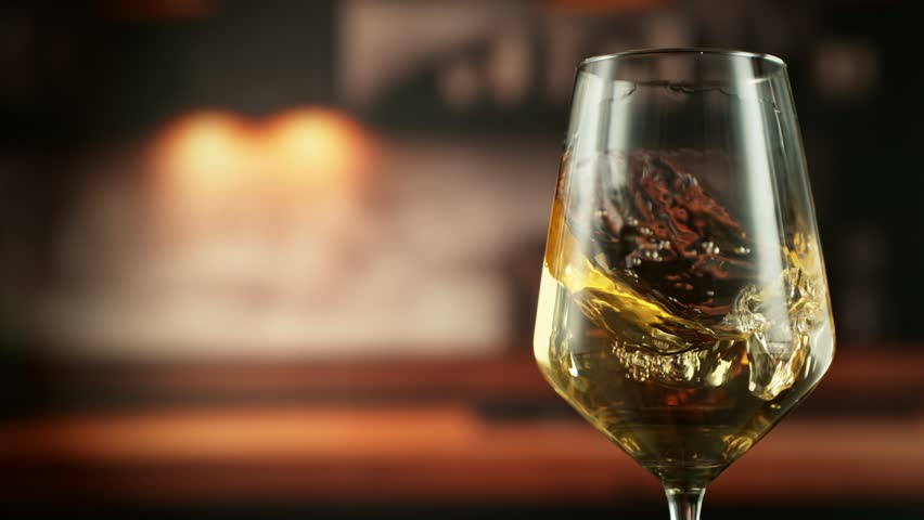 Super Slow Motion Detail Shot of Spinning White Wine in Glass at 1000fps.