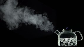 Boiling water in kettle on black background shooting with high speed camera, phantom flex.