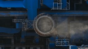 Aerial view of industrial plant with circular structure releasing steam in daytime - Powered by Shutterstock - Get 15% off with code: PIKWIZARD15