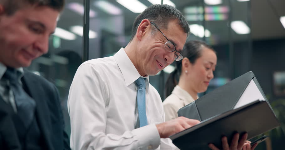 Businessman, happy and folder in office for reading, good news and smile for loan approval letter. Asian man, mature accountant or file in Japanese agency for positive performance review at coworkers