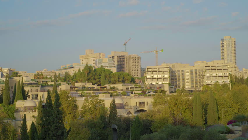 Pan Slow Motion shot of Jerusalem Skyline and Construction during Sunrise