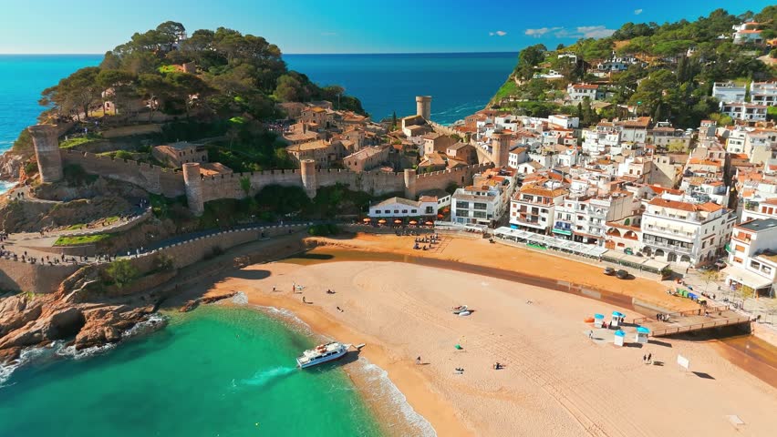 Tossa de Mar town on Costa Brava Mediterranean coast in Catalonia, Spain. Beautiful beach with turquoise color water and Tossa de Mar fortress during summer in Catalonia.