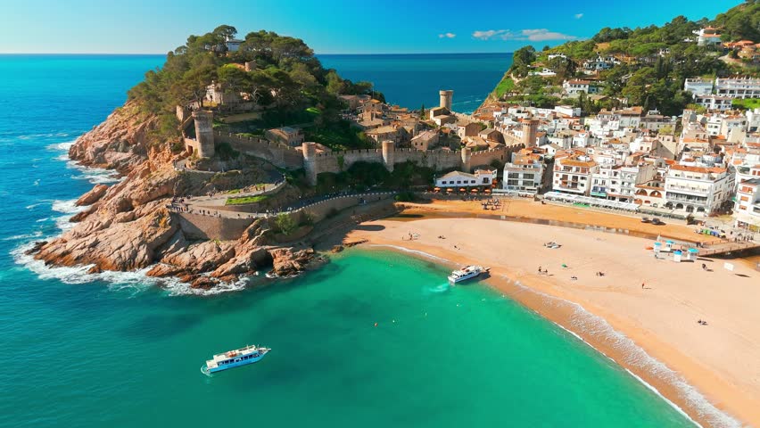 Tossa de Mar town on Costa Brava Mediterranean coast in Catalonia, Spain. Beautiful beach with turquoise color water and Tossa de Mar fortress during summer in Catalonia.