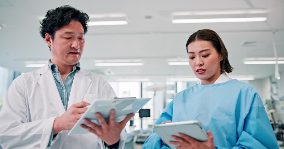 Japanese doctors, talking and tablet for teamwork in medical research, examination and healthcare. Physician, people and clipboard for nursing, wellness and results in hospital or clinic for medicine