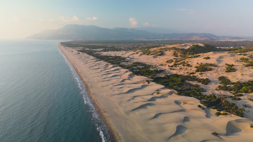 Aerial view of 14 km long Patara beach in Patara ancient city in Turkey at sunset.