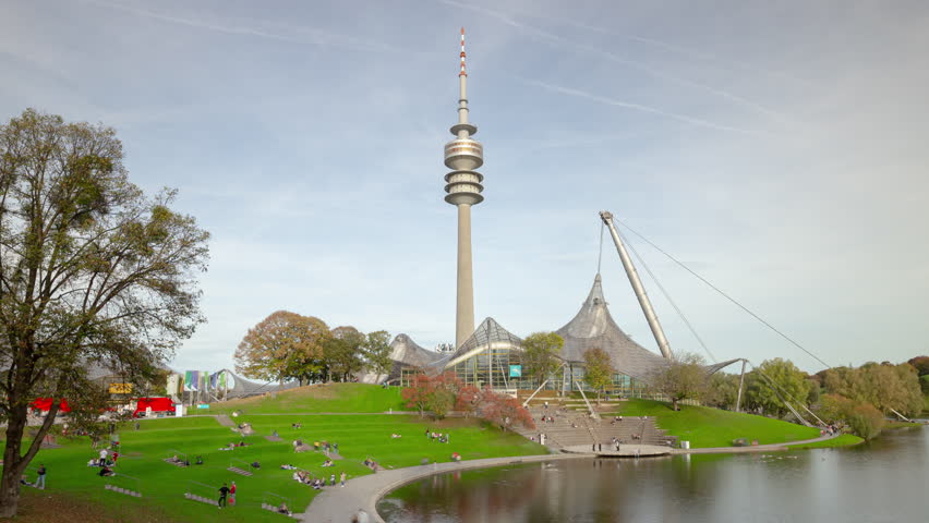 day time munich city famous stadium crowded park lakeside radio tower panorama 4k timelapse germany