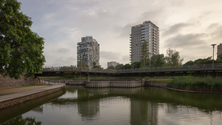 sunset time barcelona city modern residential complex park lake panorama 4k timelapse spain