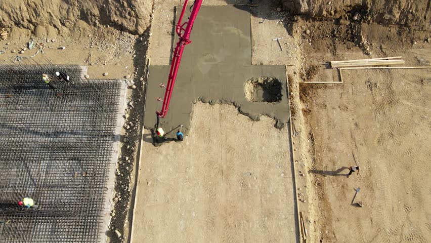 Concrete mixer pouring foundation at construction
