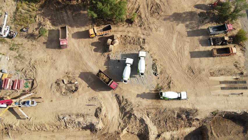 Concrete mixer pouring foundation at construction