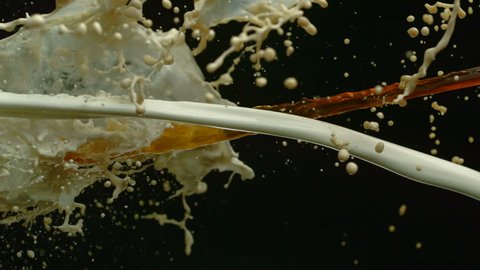 Pouring coffee & milk and making splashes on black background shooting with high speed camera, phantom flex.