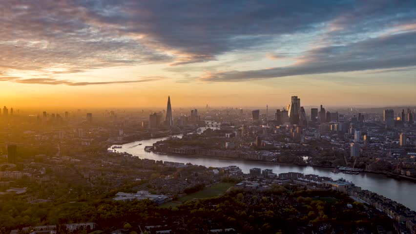 Sunset to night time lapse view of the urban cityscape of London, England, with beautiful clouds and sunlight