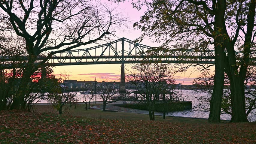 At sunrise, the iconic architecture of Boston in Massachusetts, USA showcasing the historic Tobin bridge spanning over the memorable Mystic river on a sunny morning.