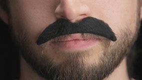 Man Wearing Artificial Mustache And Smiling - Close Up - Powered by Shutterstock - Get 15% off with code: PIKWIZARD15