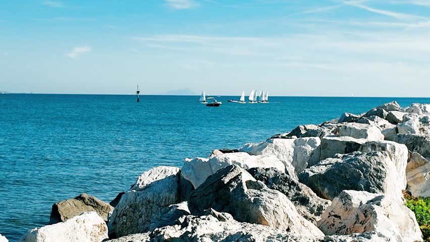 A serene view of a boat floating on calm waters in Anzio, Italy, captured in 4K resolution Perfect for travel, tourism, and maritime themes, showcasing tranquil seascapes a peaceful coastal enviroment