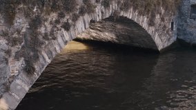 Stone bridge over a calm canal in Bruges with soft light casting shadows beneath the arch - Powered by Shutterstock - Get 15% off with code: PIKWIZARD15