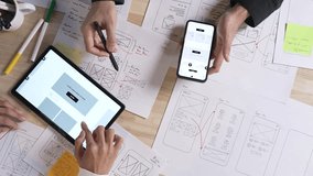 UX UI designers discussing and brainstorming on wireframes for a website and mobile app prototype, in the concept of website and mobile application design concept.  - Powered by Shutterstock - Get 15% off with code: PIKWIZARD15