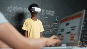 Closeup of school girl hand coding program while african student using VR interact with metaworld. Smart boy wearing virtual reality glasses and playing video games at innovative class. Edification - Powered by Shutterstock - Get 15% off with code: PIKWIZARD15