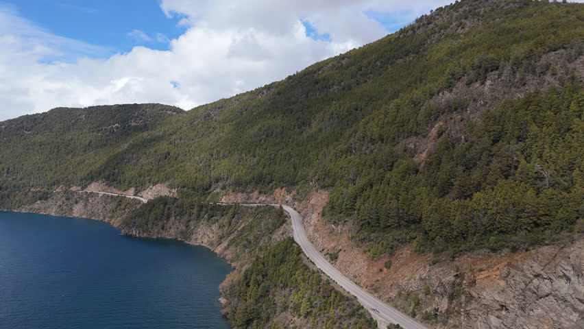 Aerial view of iconic Siete Lagos Route 40 between Lácar lake and green mountains in San Martín de Los Andes Neuquén, Patagonia Argentina