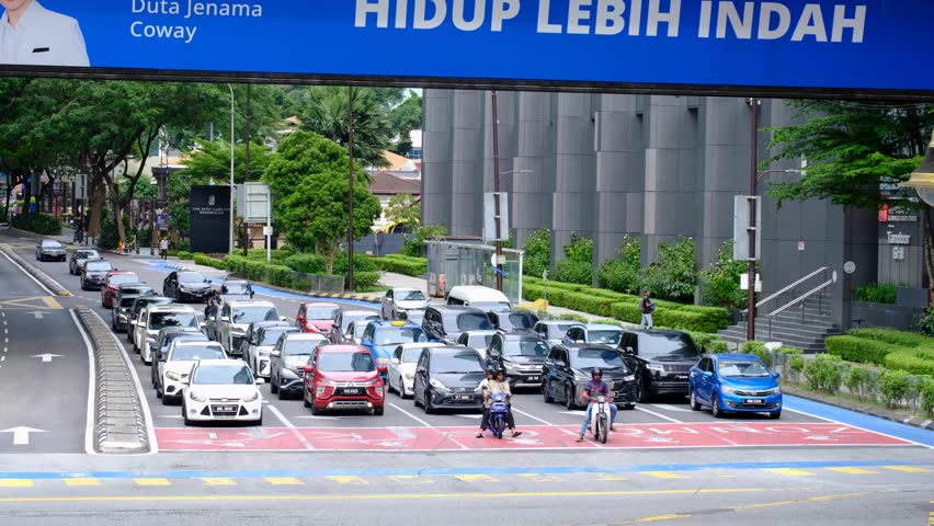 Kuala Lumpur , Malaysia - 10 31 2024: Organised traffic stopped and waiting at red lights on 5 lane highway road in capital city of Kuala Lumpur Malaysia