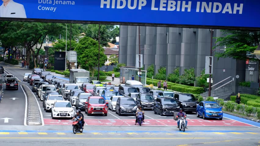 Kuala Lumpur , Malaysia - 10 31 2024: Neatly organised traffic moving and free flowing on 5 lane highway road in capital city of Kuala Lumpur Malaysia