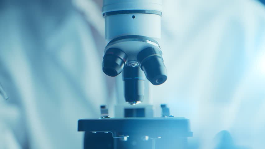 Virologist scientist using microscope in laboratory for biochemical research. Medical lab equipment, doctor researching vaccine development, studying disease to advance healthcare and treatments